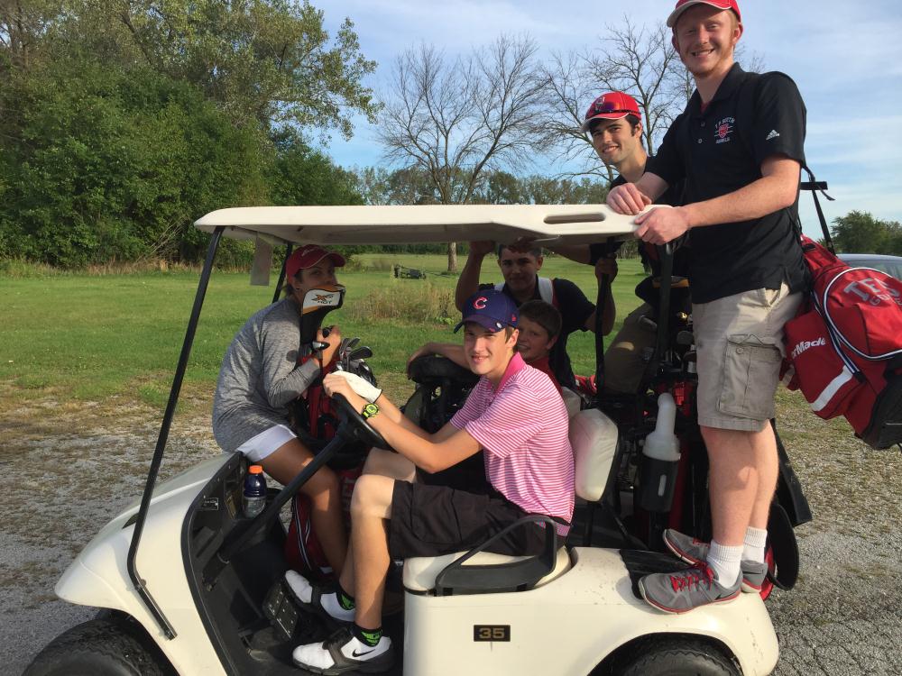 TFS golfers pile in a golf cart after a victory at LCC.